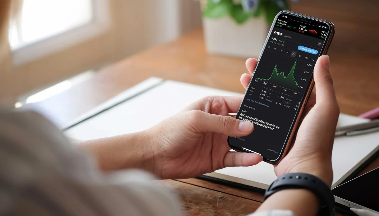 Investor checking market updates on their phone