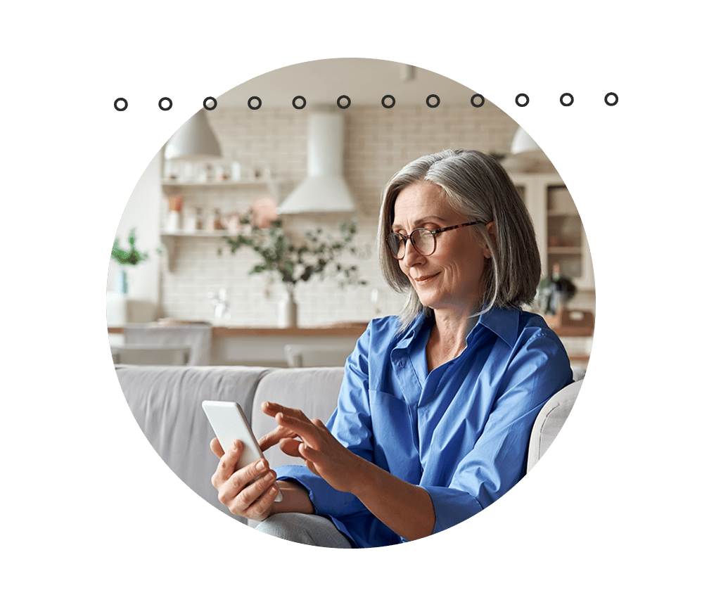Woman sitting on couch using iphone