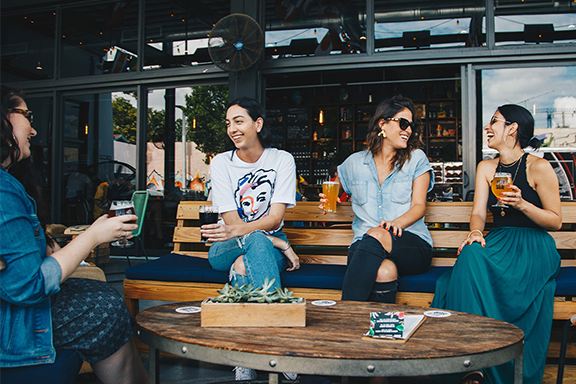 Women drinking on a restaurant's outdoor patio
