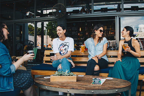 Women drinking on a restaurant's outdoor patio Women drinking on a restaurant's outdoor patio