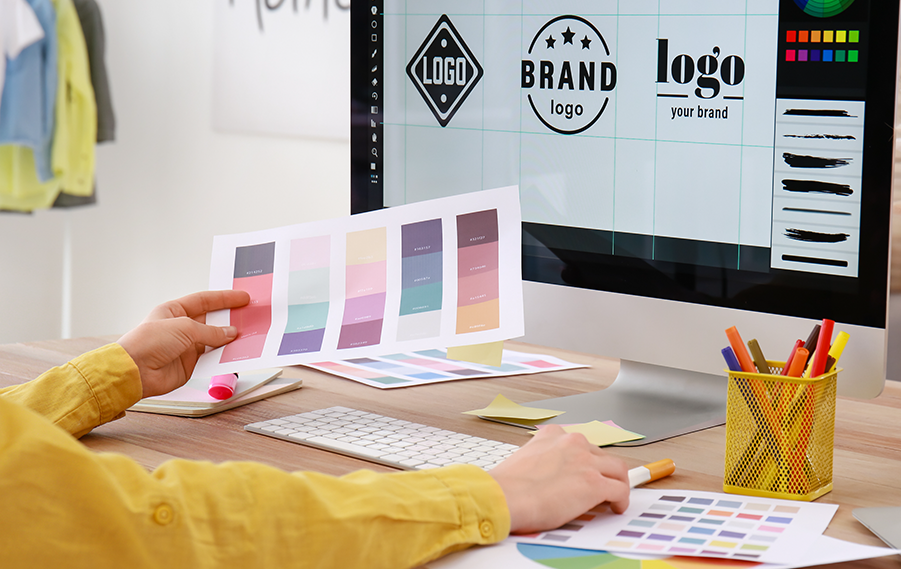 Person designing logo on computer and choosing colours